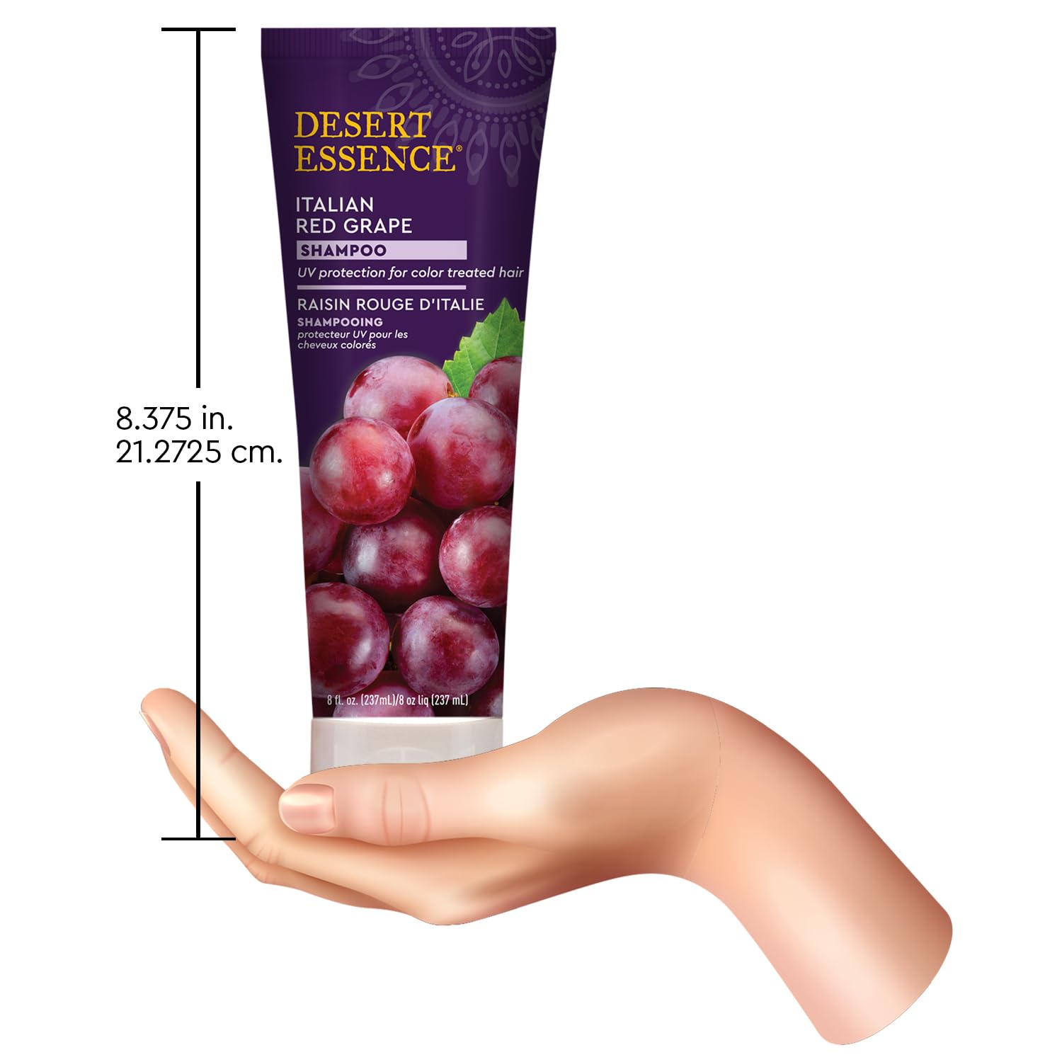 Desert Essence bottle held next to hand to display 8 ounce scale and travel convenience