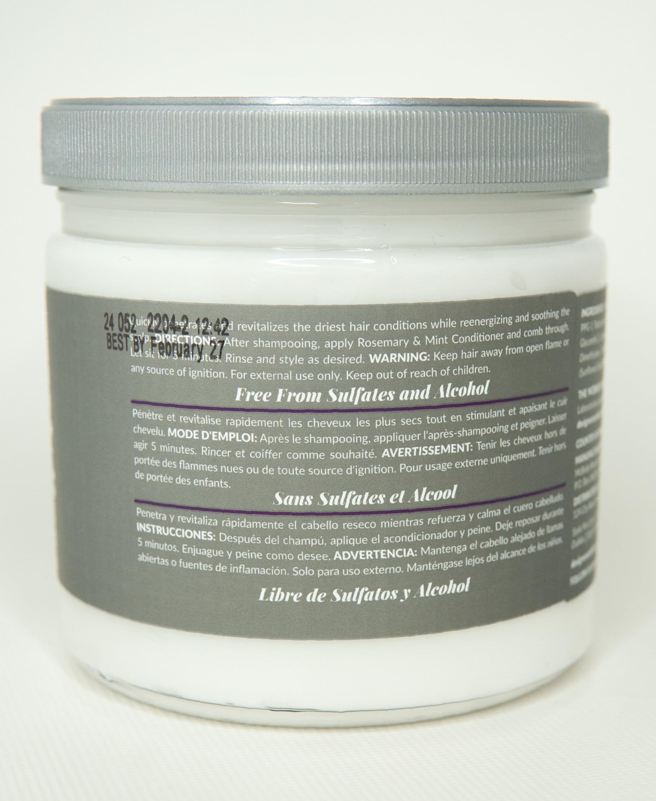 Design Essentials conditioner on hand being applied, soothes scalp and moisturizes