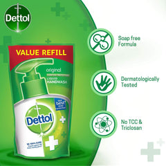 Dettol refill being poured into pump dispenser for convenient restock