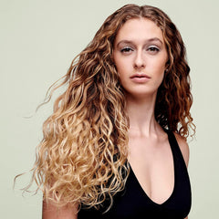 DevaCurl cream texture close-up highlighting rich moisturizing slip