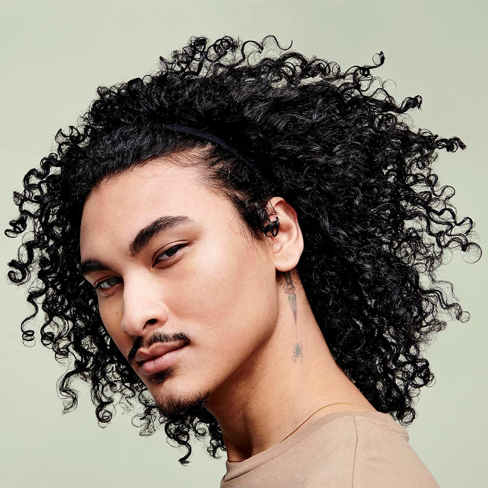 DevaCurl bottle in hand to show 7.6 fl oz scale and travel-friendly benefit