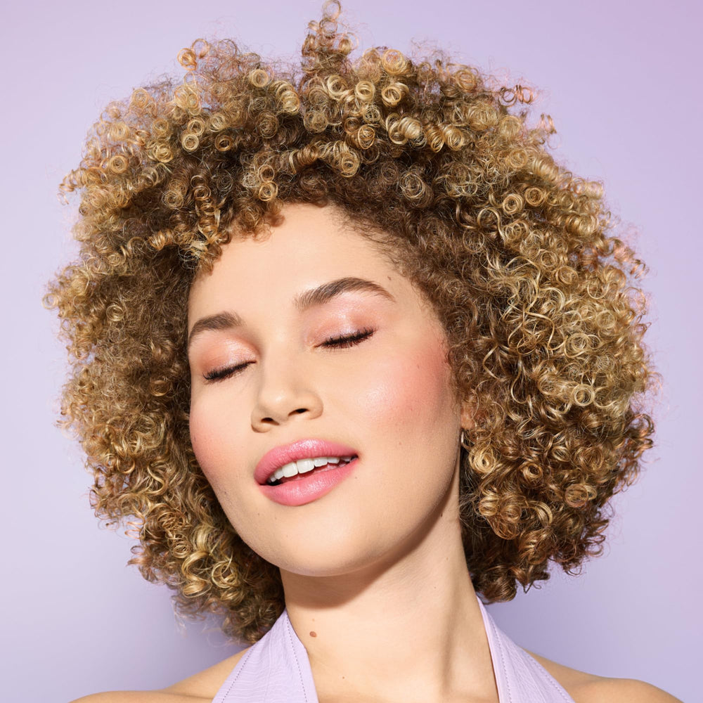 DevaCurl dispensing gel from pump illustrating controlled amount and mess-free use