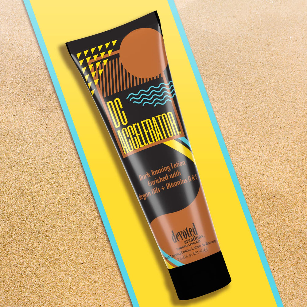 Devoted Creations bottle in sunlit setting suggesting warm fragrance and tanning support