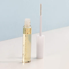 DHC Eyelash Tonic being applied to lashes to reduce breakage and improve resilience