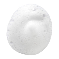 Hand holding DHC Pure Soap bar showing size and portability for routine convenience