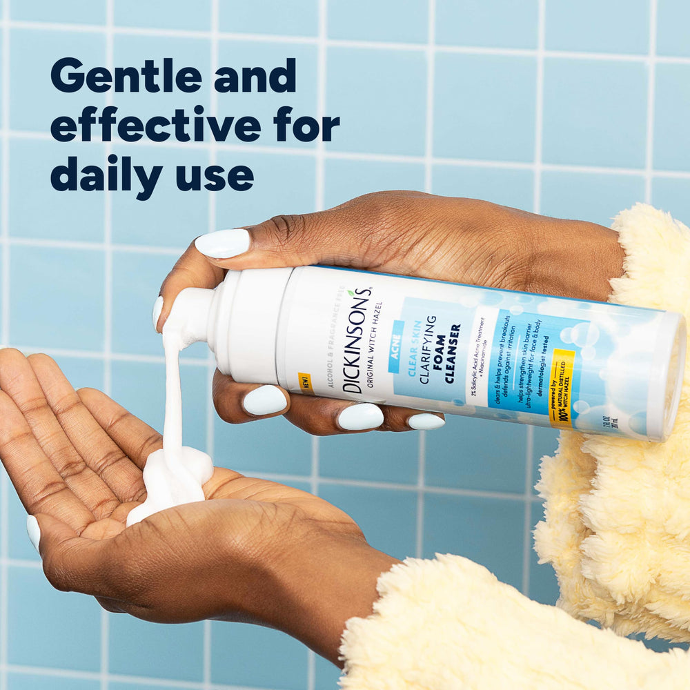 Dickinson's 7 fl oz bottle in hand illustrating compact travel-friendly size