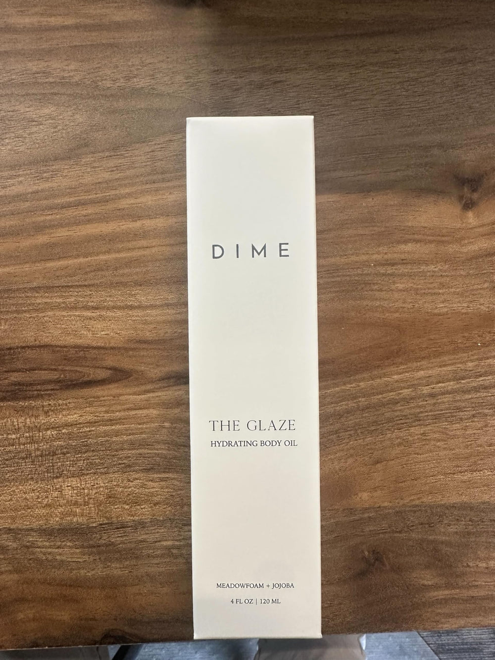 DIME bottle beside towel in bathroom showing post-shower application benefit