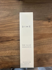 DIME bottle beside towel in bathroom showing post-shower application benefit