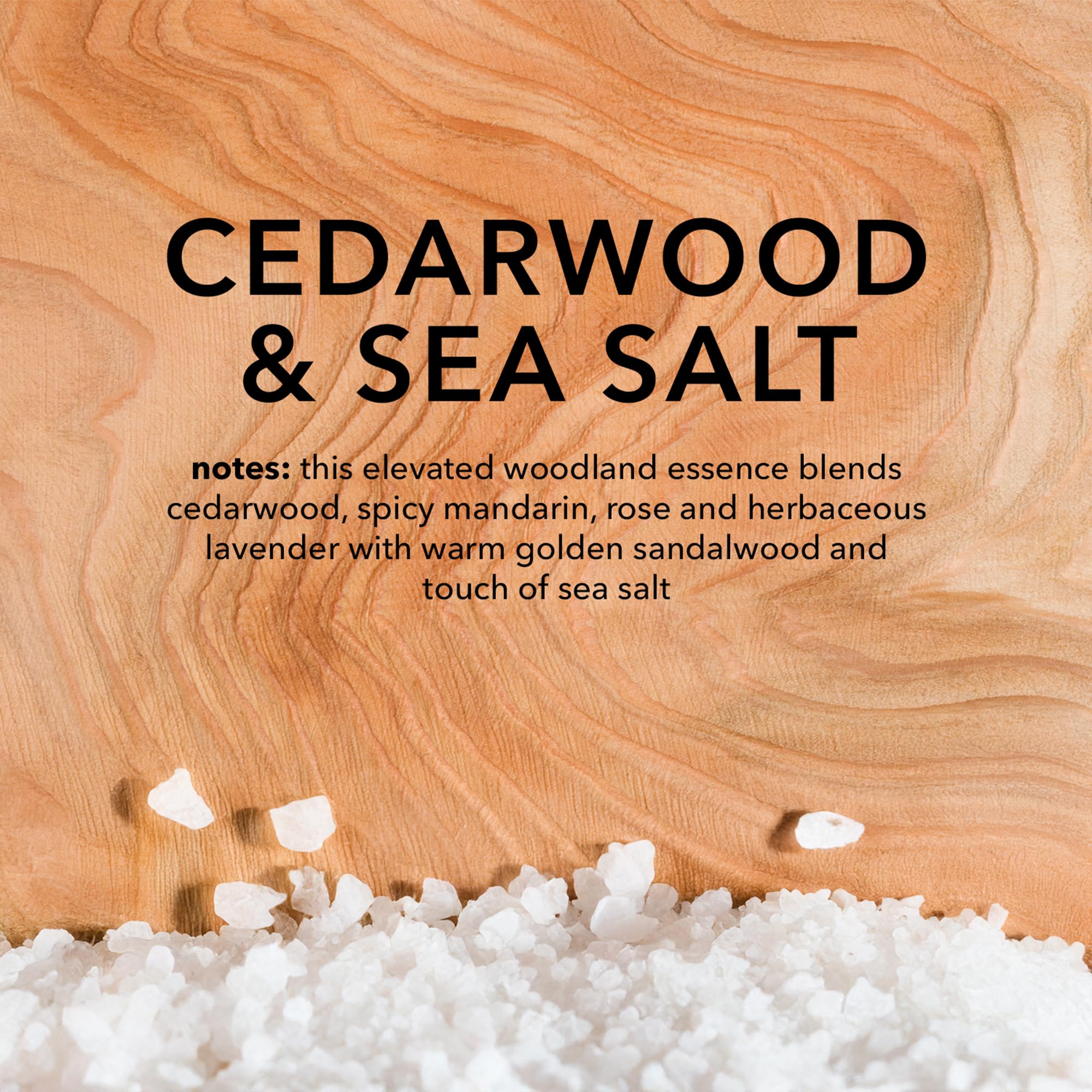 Cedarwood and sea salt props beside Dionis bottle, evokes fresh scent and daily use