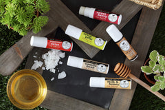 Dionis lip balm applied from hand, demonstrates easy on-the-go nourishment