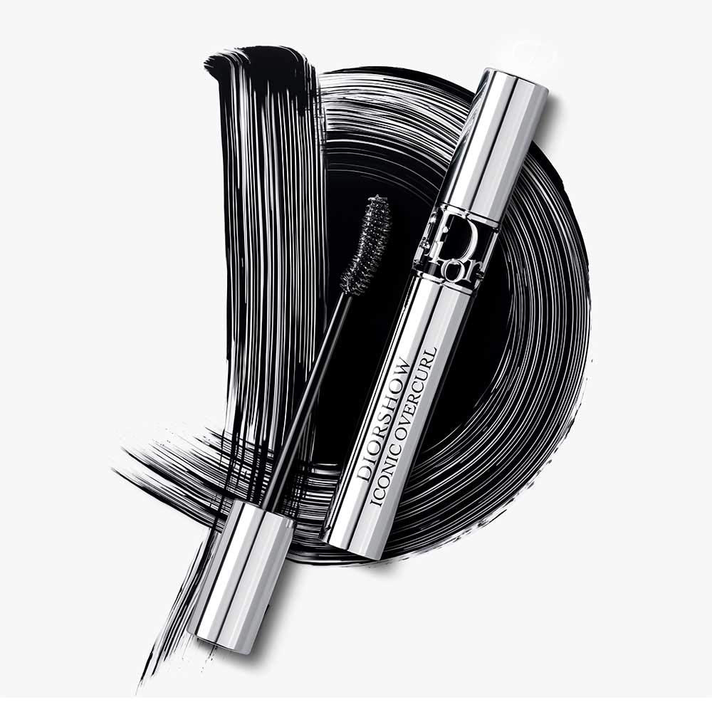 Dior product next to coin for size comparison conveying travel-friendly portability
