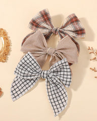 doboi baby wearing bow outside, conveys comfortable styling for photos