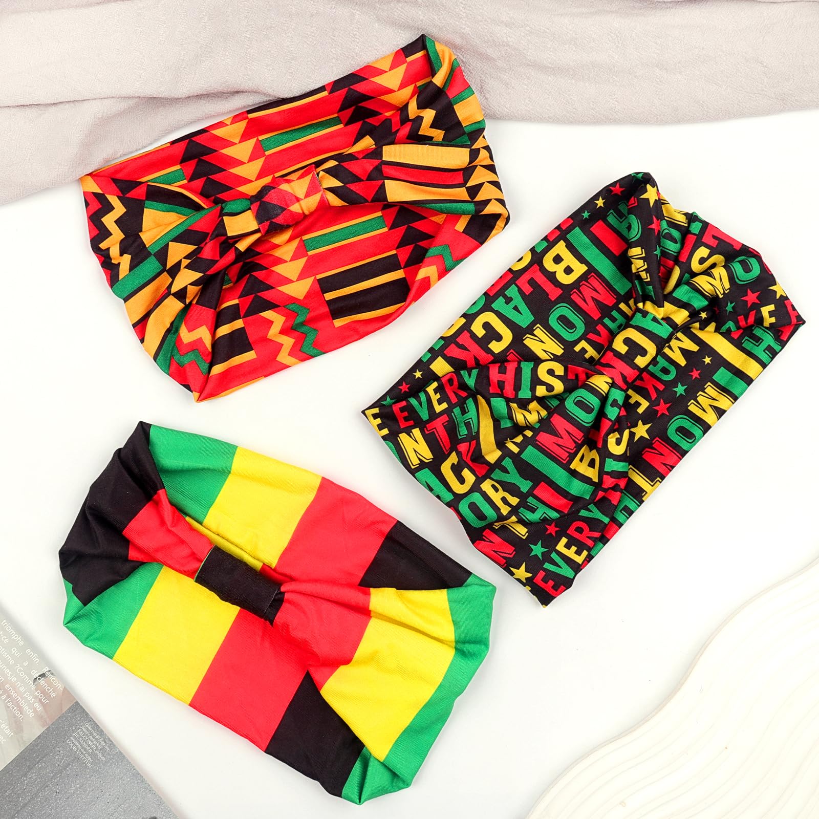 Doneace three headbands stacked to display red yellow black green coordination