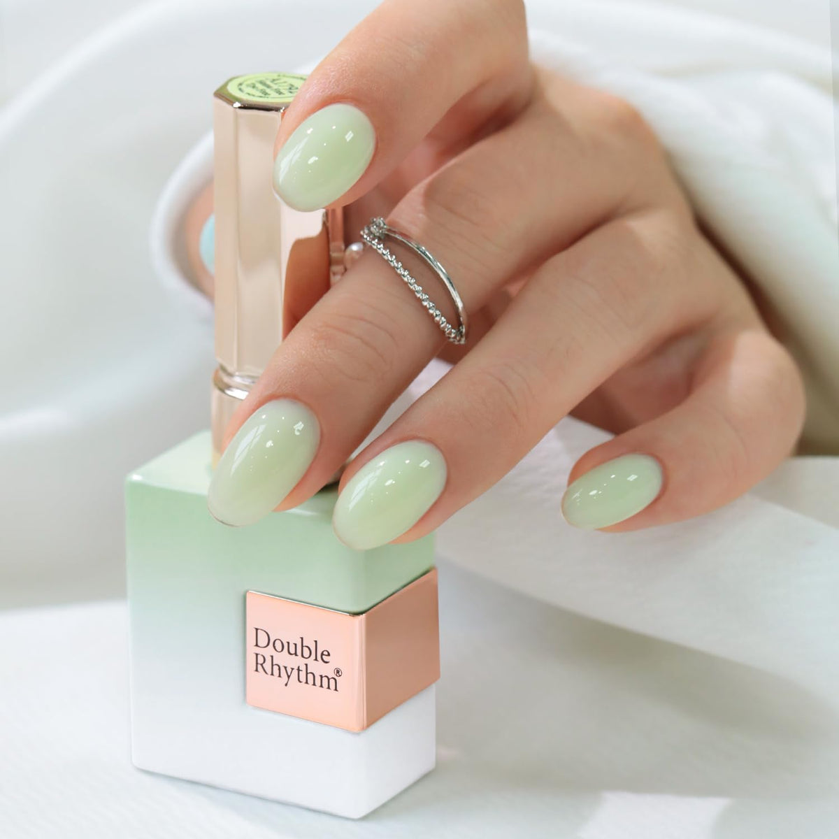 Double Rhythm front bottle view showing milky green shade and glassy finish benefit