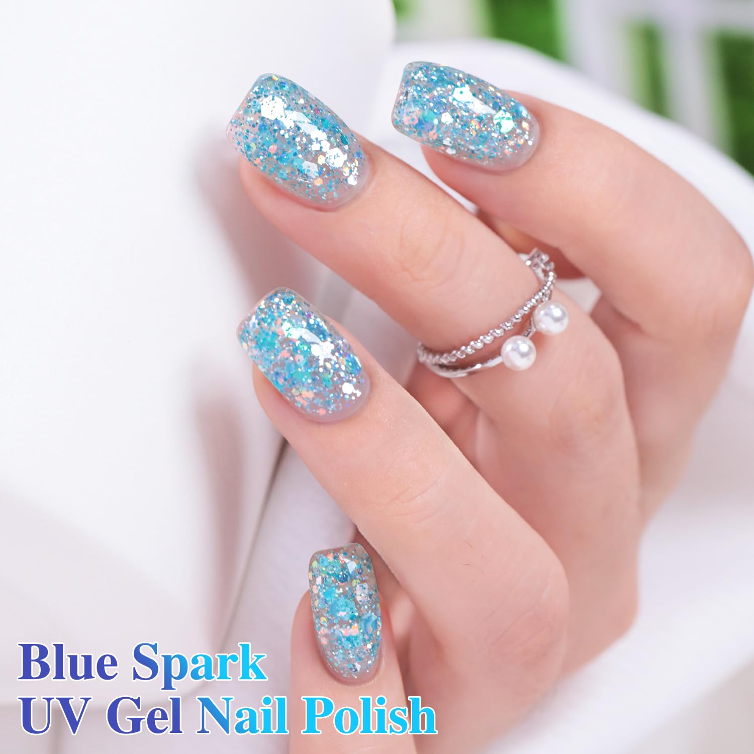 Hand with nails painted in Double Rhythm Sparkle Blue showing salon-quality finished look