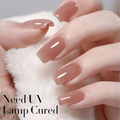 Double Rhythm swatch on fingertip demonstrating buildable milky nude coverage