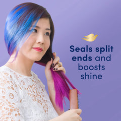 Applying Dove serum to damp hair for smoothness and frizz control