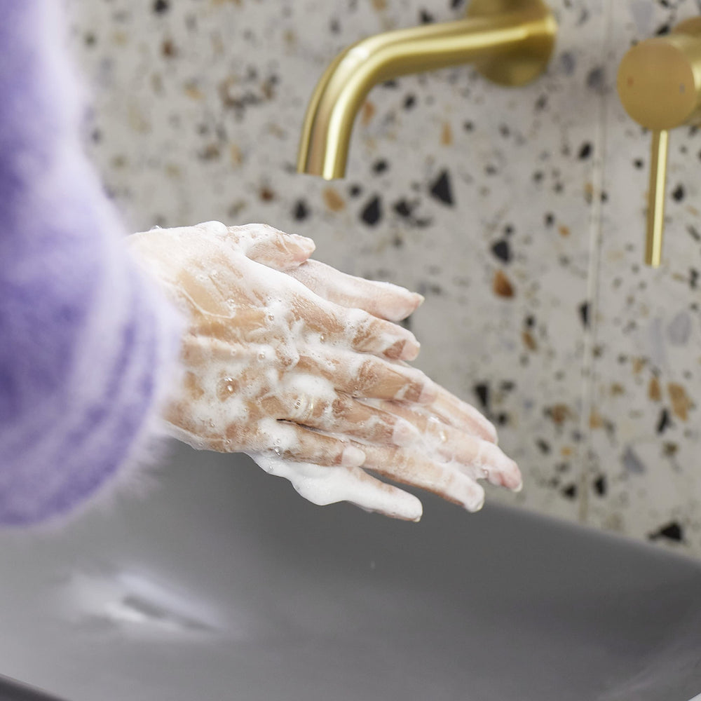 Dove hand wash in use at a kitchen sink demonstrating soft hands benefit