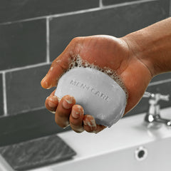 DOVE MEN + CARE bar close-up texture highlighting moisturizing cream benefit