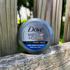 Dove Men+Care tube beside a coin to show compact size and travel-friendly benefit