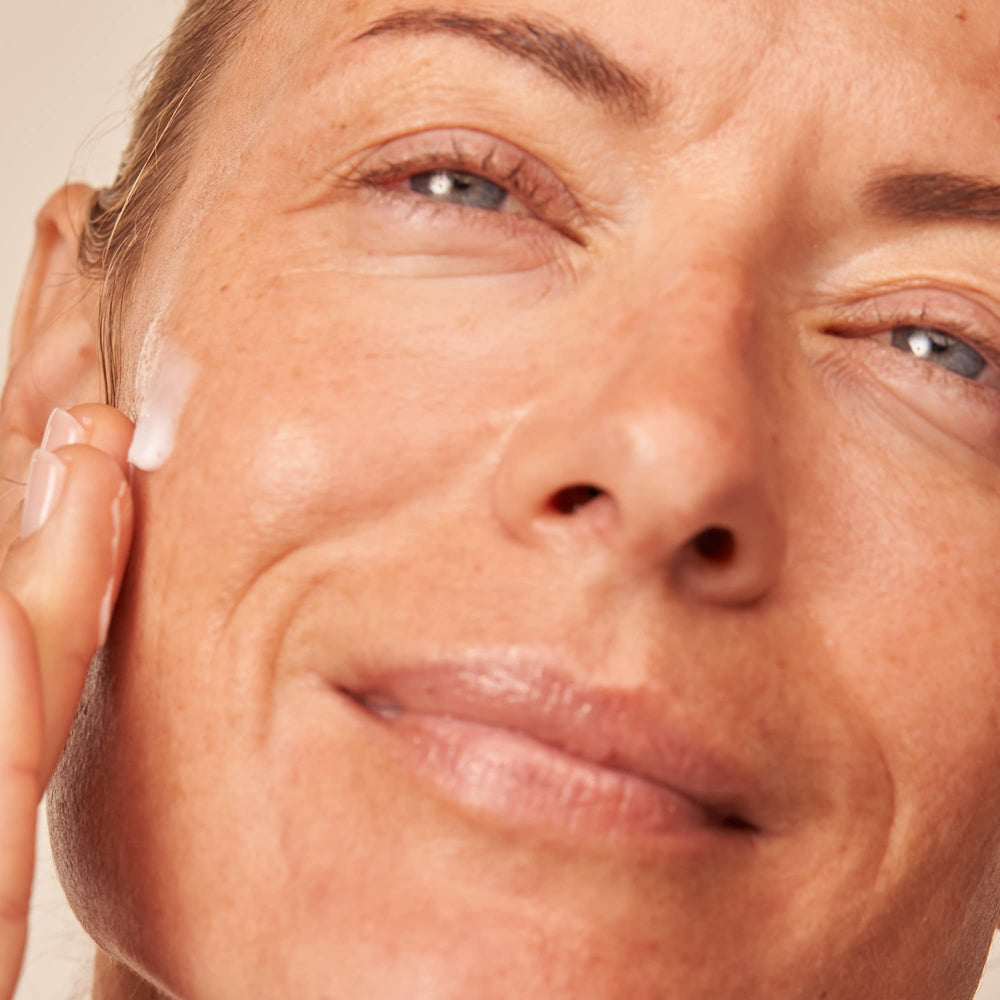 Dr Dennis Gross cream being smoothed onto skin demonstrating nourishing application