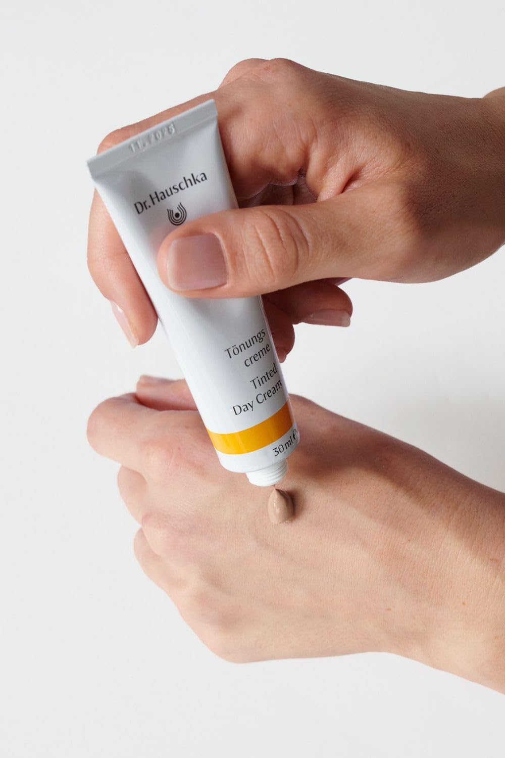 Dr. Hauschka bottle staged with skincare routine for daily use