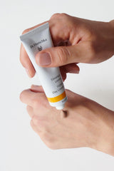Dr. Hauschka bottle staged with skincare routine for daily use