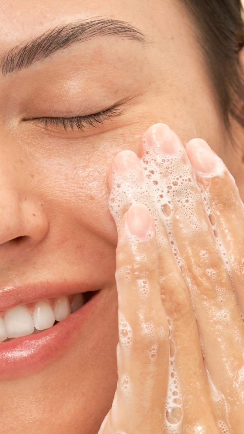 Dr. Loretta cleanser being massaged onto wet face, confirming effective makeup removal