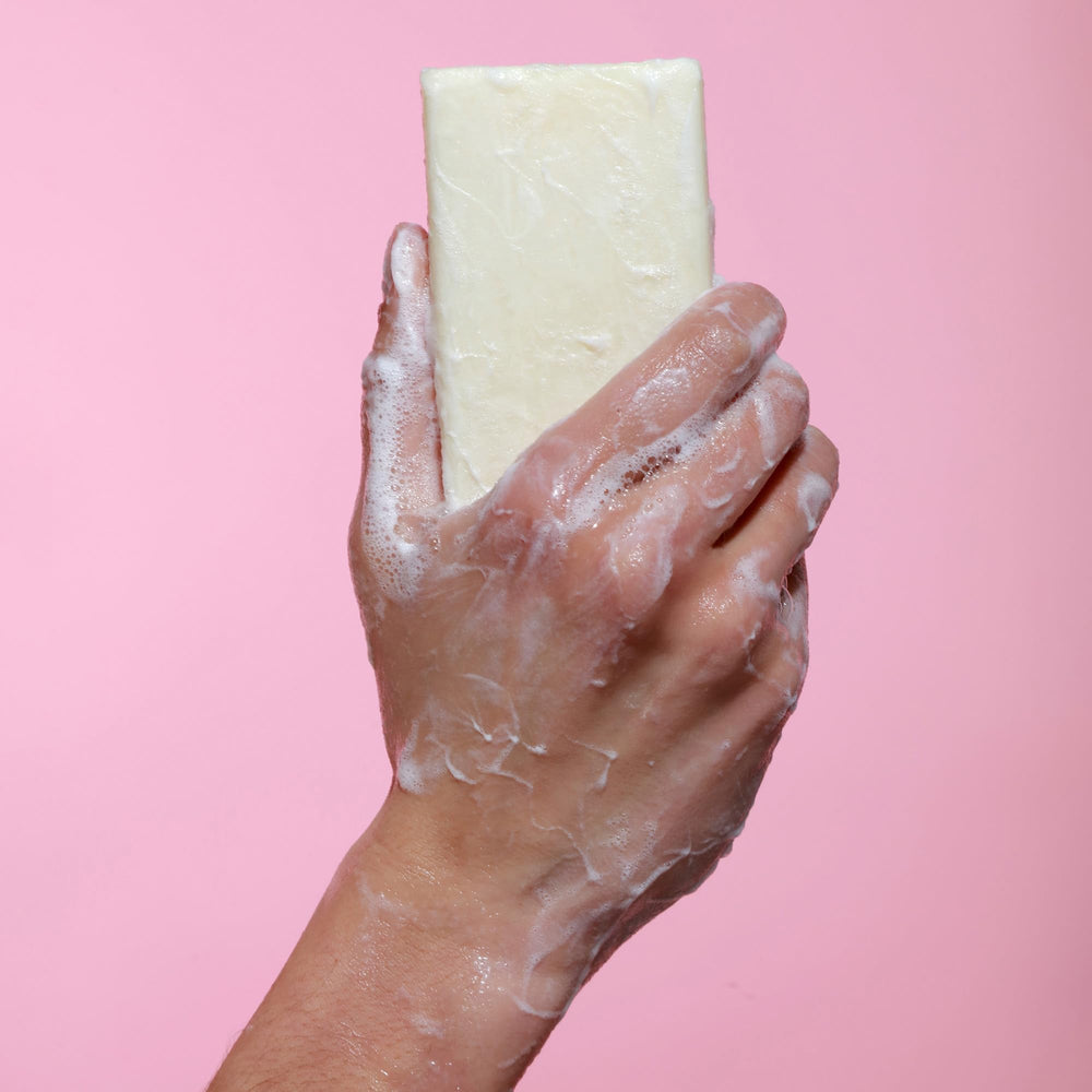 Dr. Natural bar placed on shower shelf illustrating practicality and long-lasting use benefit