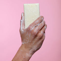 Dr. Natural bar placed on shower shelf illustrating practicality and long-lasting use benefit