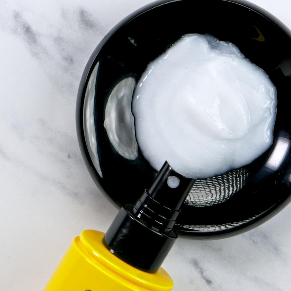 Dr. PAWPAW sprayed on damp hair demonstrating frizz control benefit