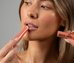 Dr. PAWPAW ORIGINAL BALM pink shimmer swatch on hand for subtle glow