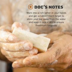 Natural ingredients with coconut, shea butter, and kaolin clay beside Dr. Squatch bar for skin nourishment