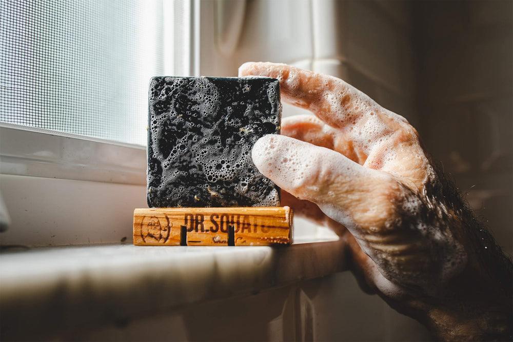 Dr. Squatch pine tar in shower lifestyle shot showing usage benefit: conveys real-world application