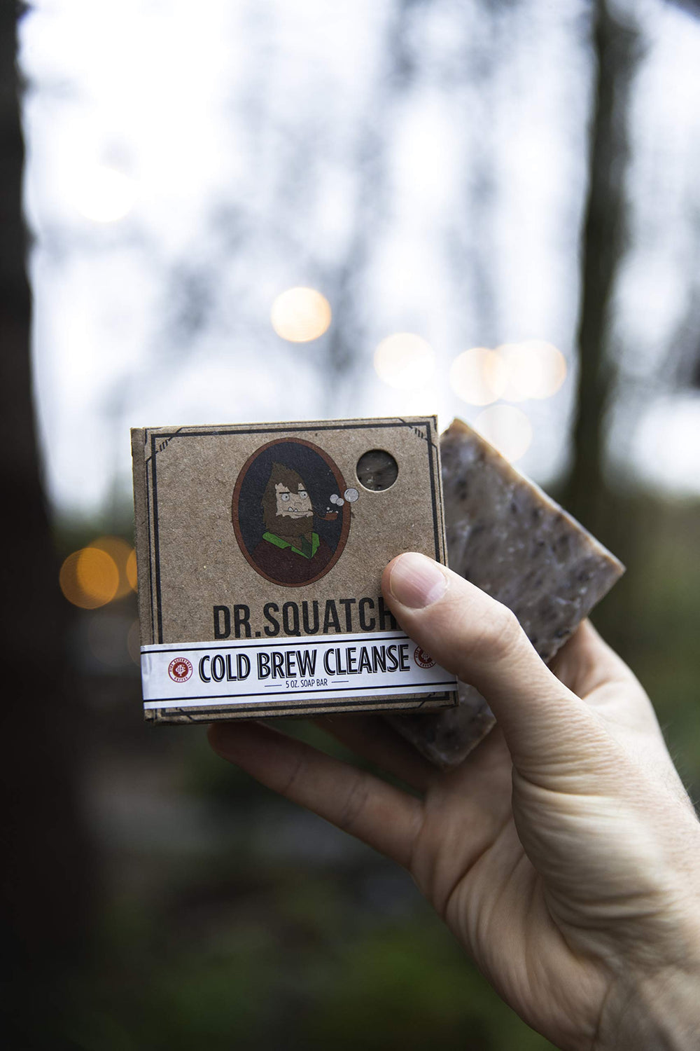 Dr. Squatch soap in hand for size and grip, showing convenient travel-friendly bar