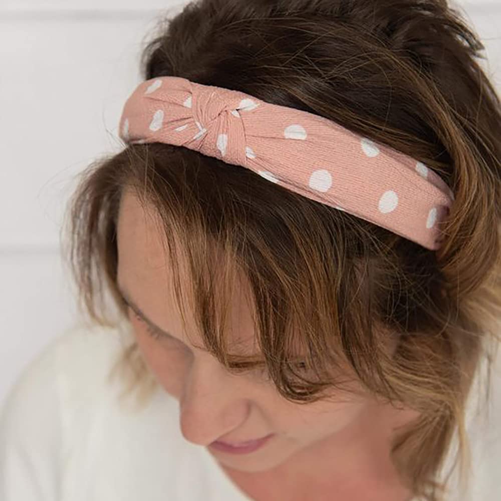 DRESHOW hand holding headband showing scale and lightweight benefit