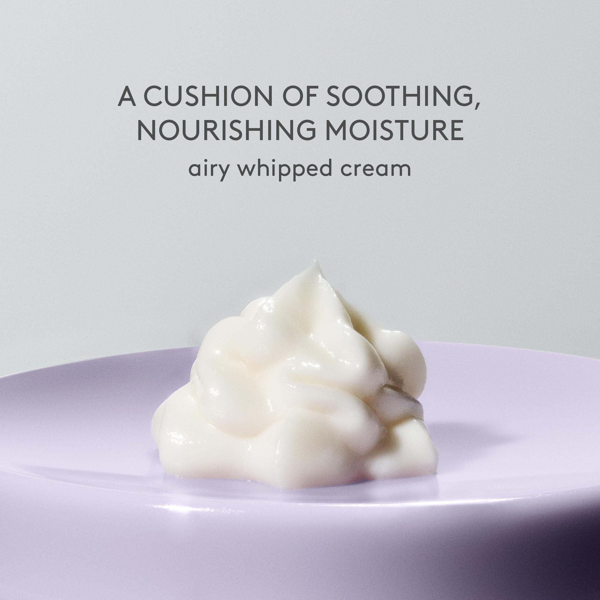 Drunk Elephant cream being scooped onto hand showing smooth application benefit