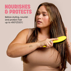Drybar travel-size bottle held in hand for easy portability benefit