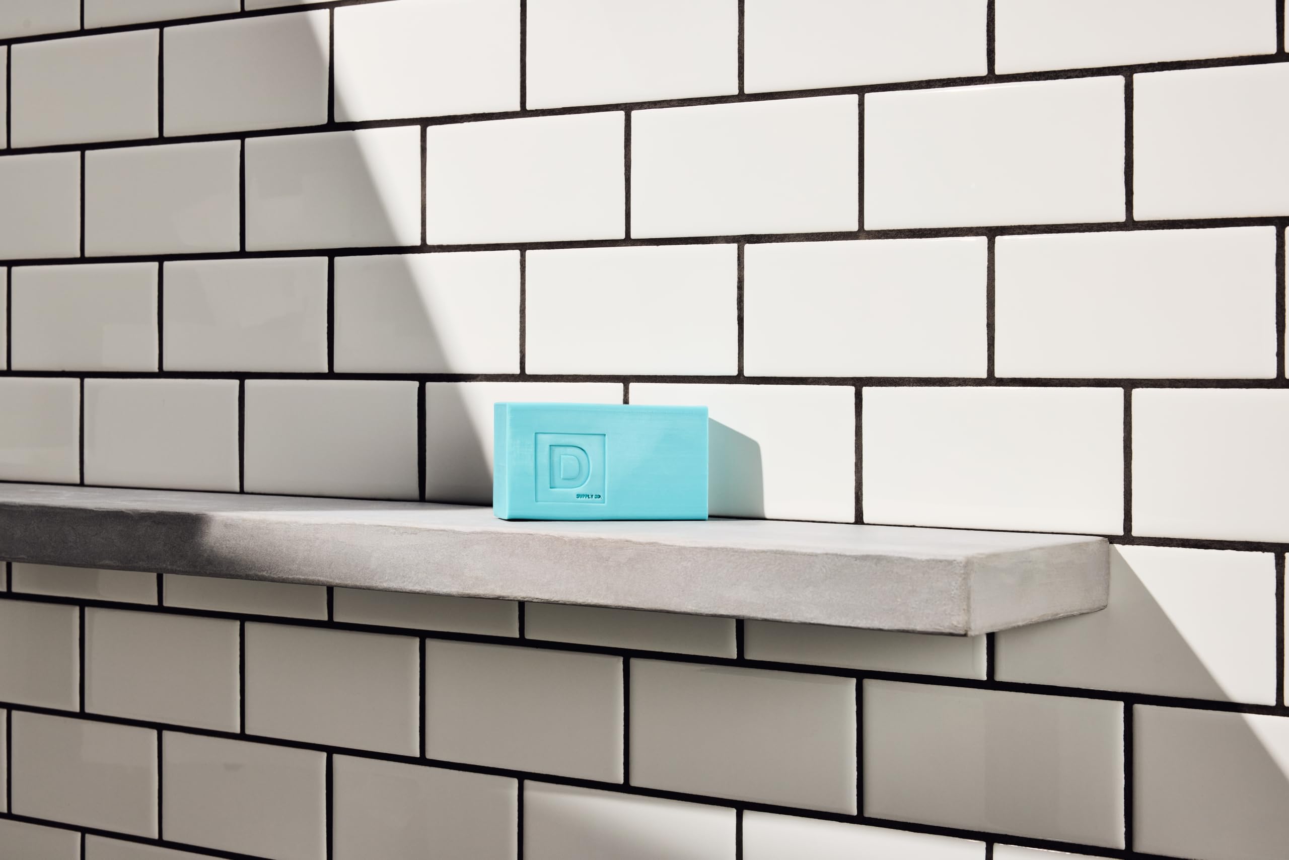 Duke Cannon bar on shower shelf illustrating durable soap for daily routines.
