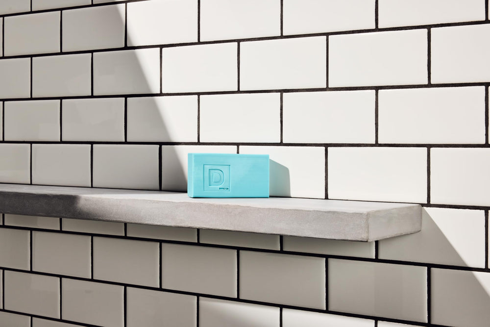 Duke Cannon bar on shower shelf illustrating durable soap for daily routines.