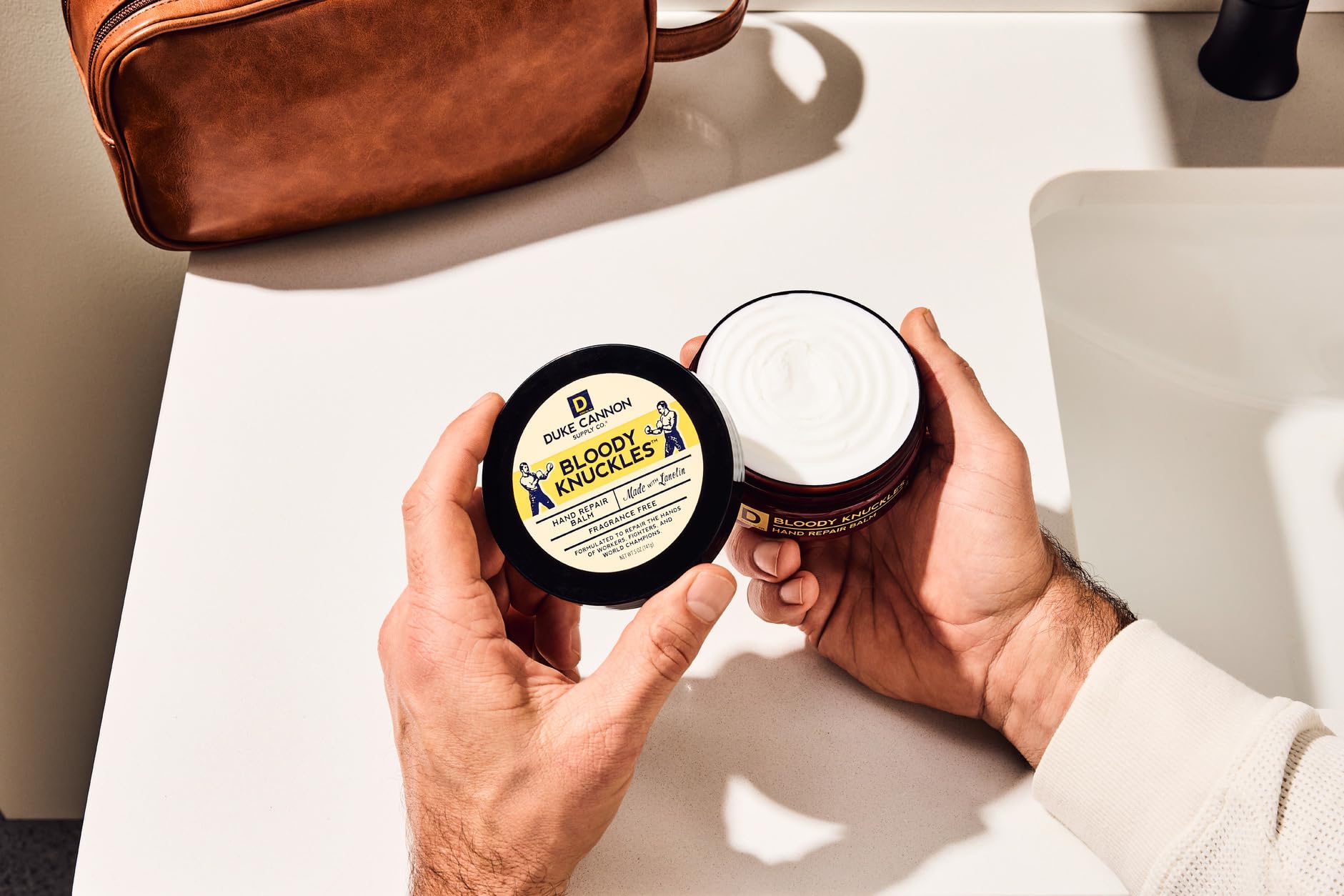 Label close-up on Duke Cannon tin highlighting unscented ingredient benefit
