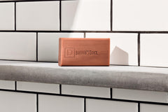Duke Cannon bar on bathroom tray suggesting durable storage and quick drying benefit