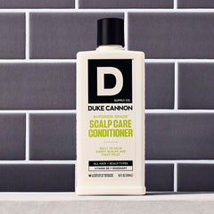 Duke Cannon label close-up with rosemary and arnica callouts, botanical soothing benefit