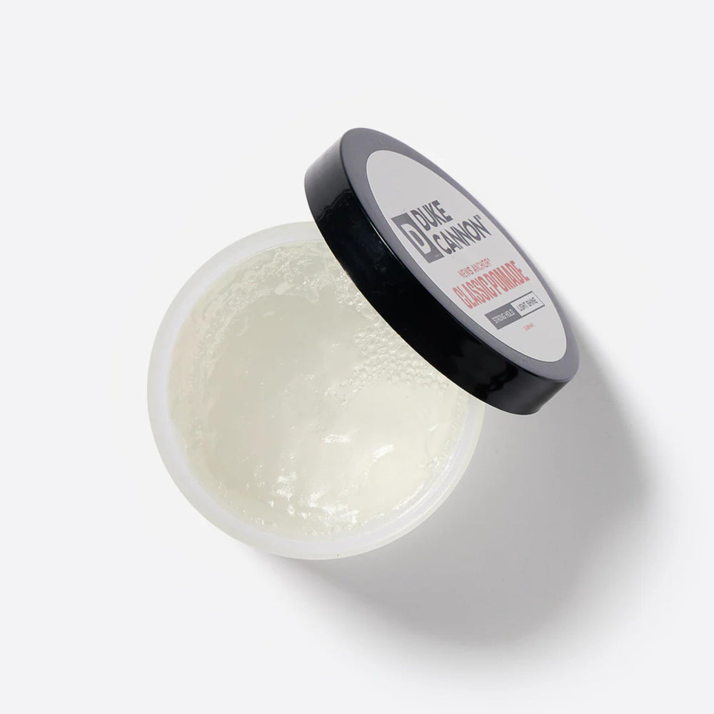 Duke Cannon texture close-up showing creamy matte pomade for controlled styling