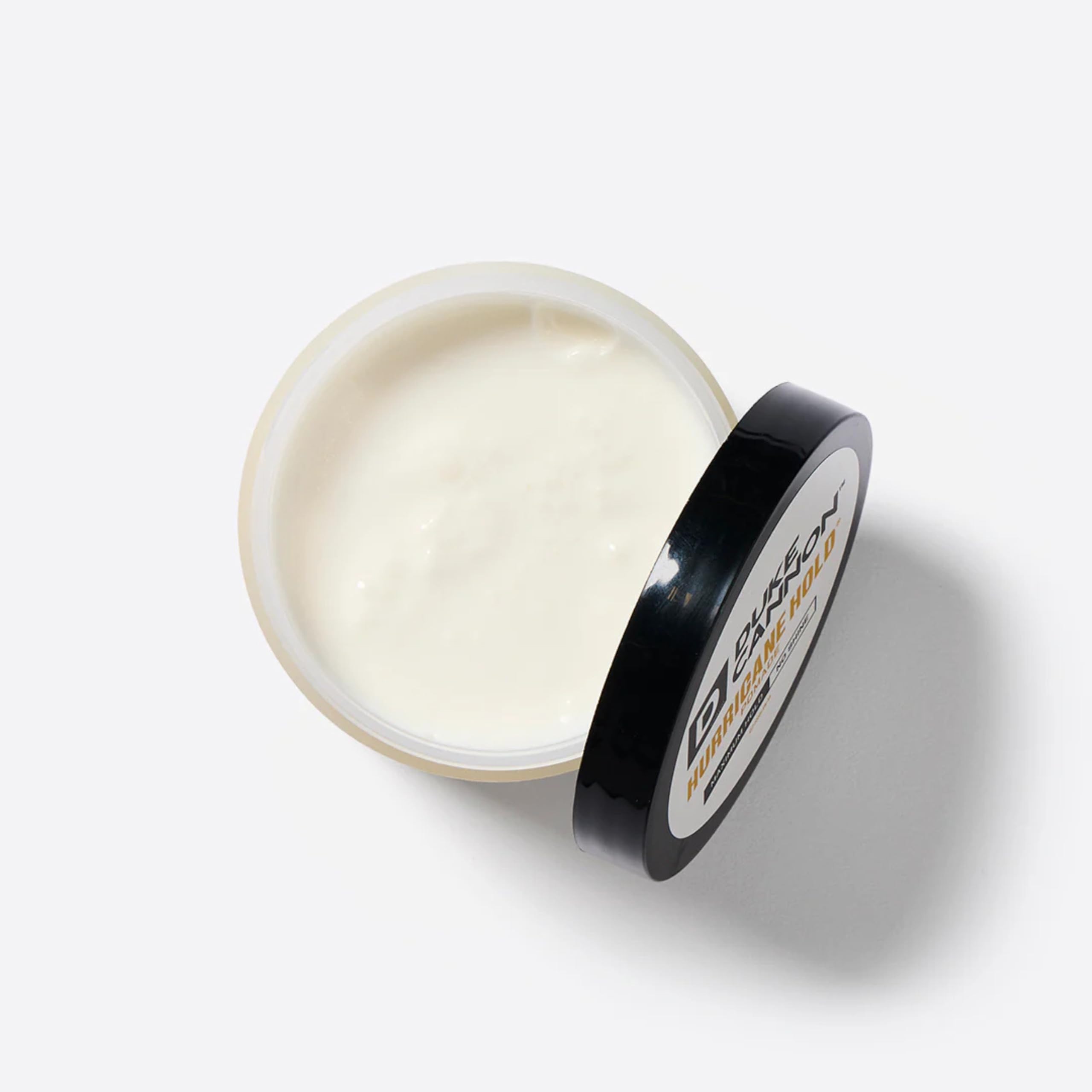 Model with styled hair using Duke Cannon pomade showing long-lasting matte hold benefit