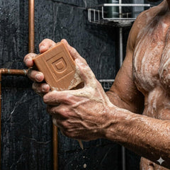 Duke Cannon bar in shower lifestyle image showing energizing morning routine benefit