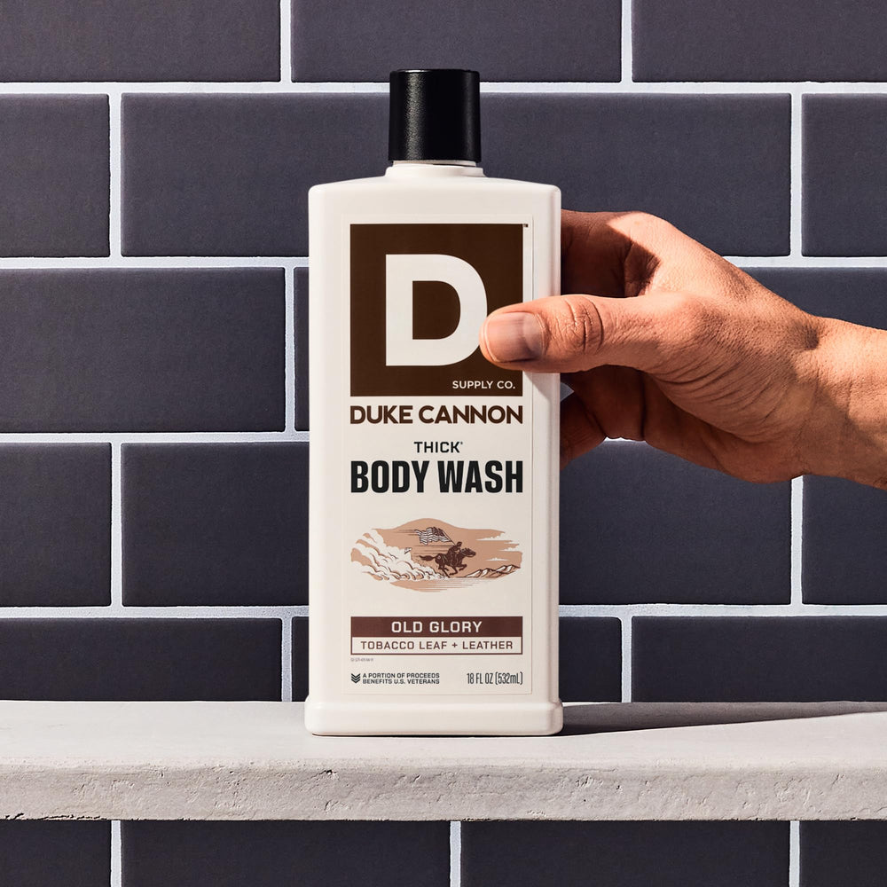 Duke Cannon in-shower use with loofah illustrating effective scrubbing