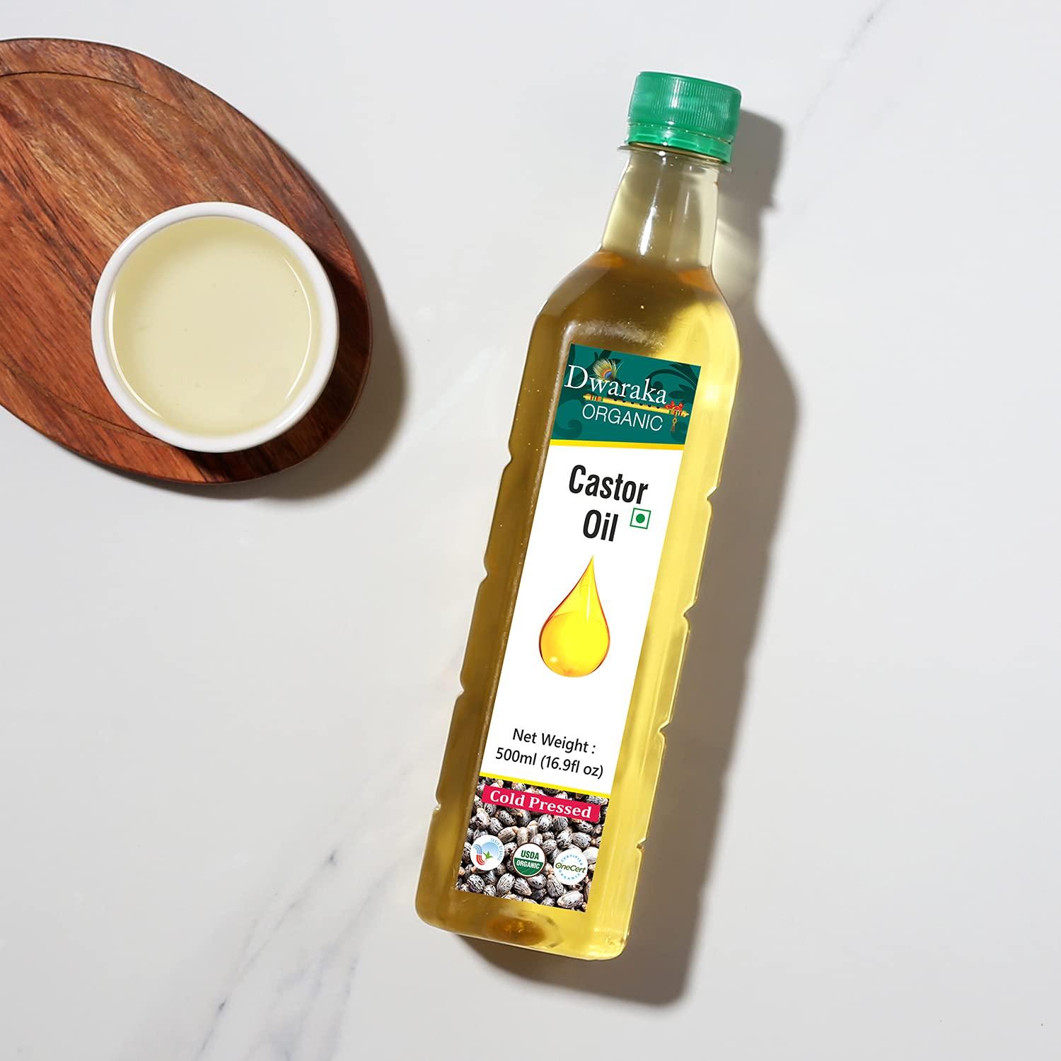 DWARAKA castor oil applied to hair roots demonstrating conditioning and manageability
