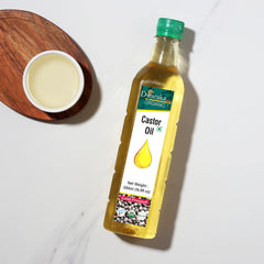 DWARAKA castor oil applied to hair roots demonstrating conditioning and manageability