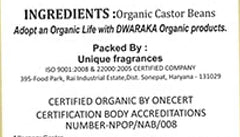 DWARAKA castor oil 500ml bottle held in hands to show scale and practical size